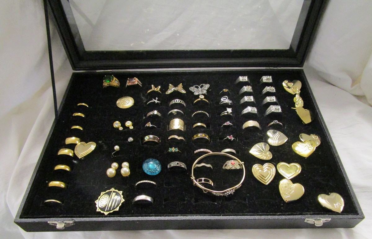 Display case of costume jewellery to include rings & brooches