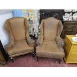 His & hers hide wingback armchairs