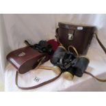 2 sets of binoculars in leather cases