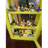 Display case of Lego figures, Action man with original sleeping bag, various Rupert annuals,