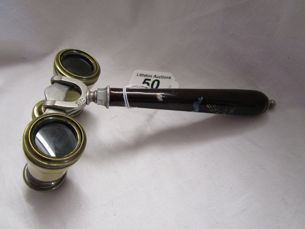 A pair of late 19th century French opera glasses together with an unusual tapered handle.