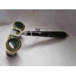 A pair of late 19th century French opera glasses together with an unusual tapered handle.