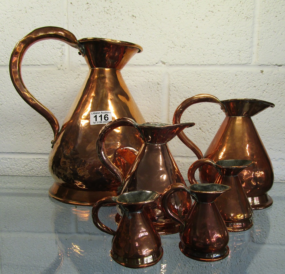 Set of 6 graduated copper jugs