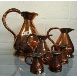 Set of 6 graduated copper jugs