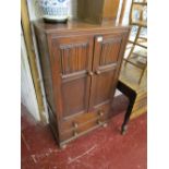 Oak linen-fold cupboard