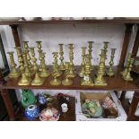 Large collection of brass candlesticks