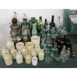 Large collection of antique bottles, stone jars & lamps etc