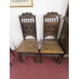 Pair of carved oak hall chairs