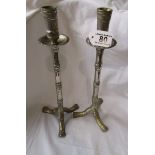 Pair of white metal candlesticks