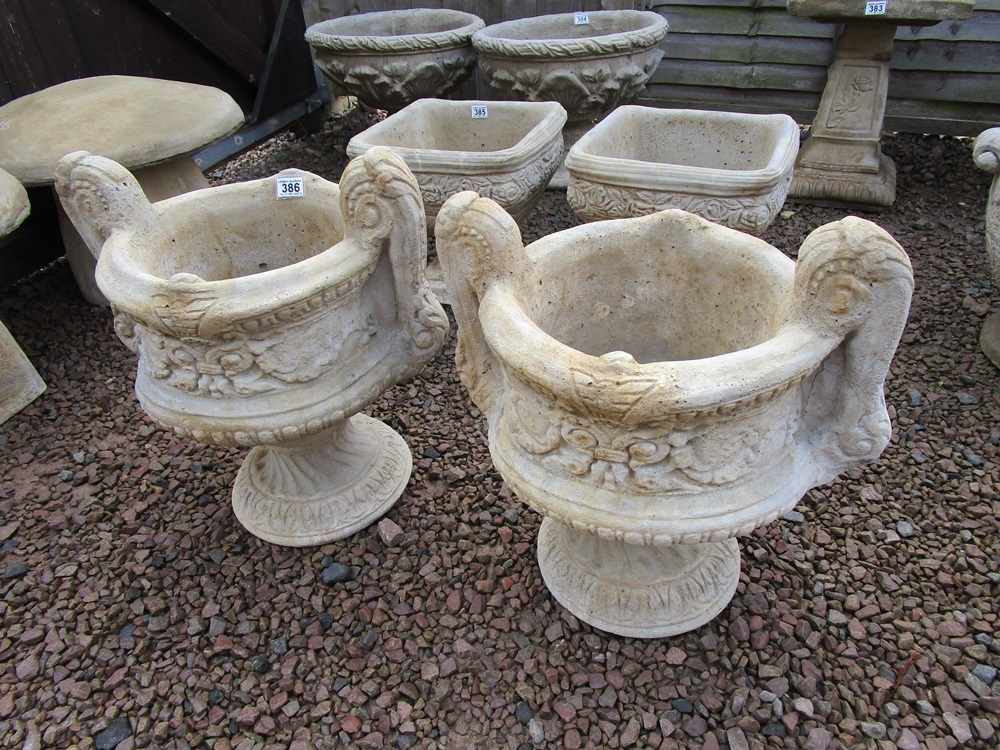 Pair of stone pedestal planters with handles