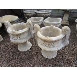 Pair of stone pedestal planters with handles