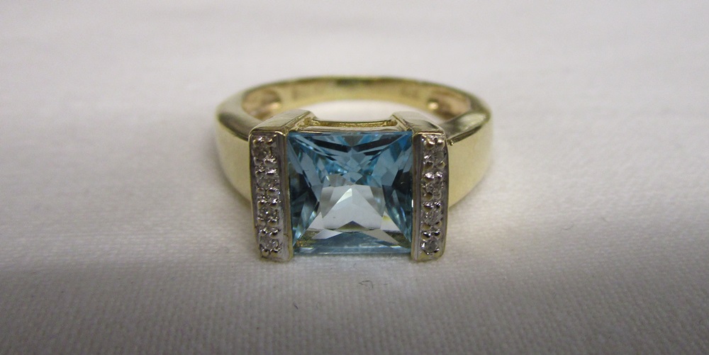 Gold designer blue topaz and diamond set ring