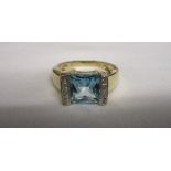 Gold designer blue topaz and diamond set ring