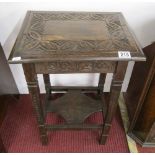 Small carved oak table with lower tier