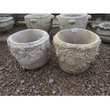 Pair of stone circular flowered planters