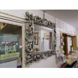 Ornate silver framed and bevelled glass wall mirror