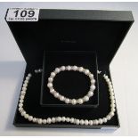 Faux pearl necklace together with matching bracelet