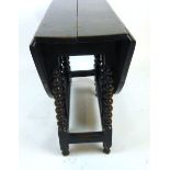 An 18th century oak gate leg table the oval top supported on two single gate actions with bobbin