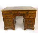 An early 18th century style walnut twin pedestal desk,