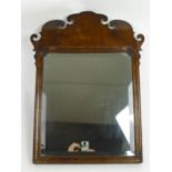 A mid 18th century walnut fretwork mirror with re-entrant moulded corners to the top of the frame