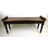 A 19th century mahogany window bench with baluster ends on turned legs. h. 46 cm, w. 106 cm, d.
