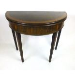 A late 18th century mahogany, tulipwood crossbanded and boxwood line inlaid demi-lune card table,