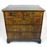 An early 18th century walnut chest of two over three drawers,