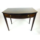 A George III mahogany bow fronted writing table,