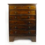 An early 19th century style mahogany chest of six long drawers with brass knobs on bracket feet. h.