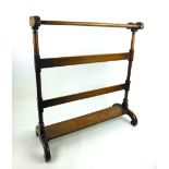 A Victorian mahogany towel rail, the double bar top on turned end supports on C-scroll legs. h.