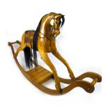 A reproduction carved pine rocking horse with horse hair mane and tail,