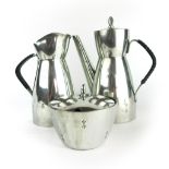 Four items of Norwegian Pewter including a three piece tea set and a pot and cover