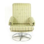 A 1970's cloth lounge armchair on a chromed swivel base