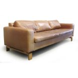 A Danish tan leather three seater sofa on an oak frame