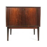 A 1960's Danish rosewood bar cabinet, the fall front enclosing a fitted interior,