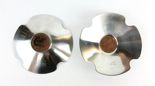Robert Welch for Old Hall, a set of five stainless steel dishes inset with pennies,