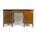 A 1960's beech and teak bow fronted desk with an arrangement of five drawers and a door, l.