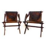 A pair of Victorian oak Glastonbury chairs with ecclesiastical carving to back and Gothic top rail