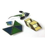 Three silver and enamelled brooches, one in the form of an orchid,