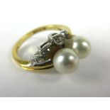 An 18ct yellow gold and platinum highlighted ring set a pair of cultured pearls and small diamonds