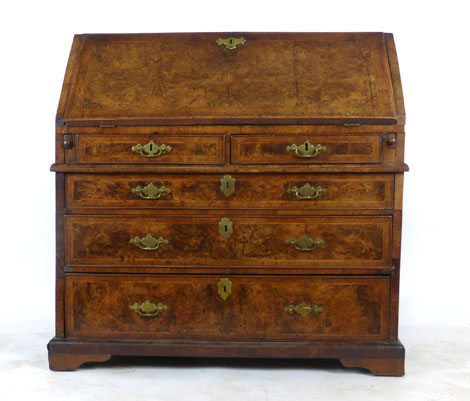 An early 18th century walnut herringbone line inlaid and crossbanded bureau,