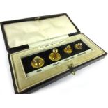A cased set containing four 9ct yellow gold dress studs,