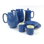 A group of 1930's Moorcroft tablewares in a royal blue glaze including water and milk jugs,