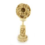 A 19th century Chinese ivory concentric puzzle ball on a matching stand, h.