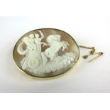 An 18ct yellow gold mounted cameo brooch of oval form depicting two classical figures riding a