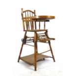 An Edwardian beech and elm child's high chair converting to stroller and play table. h. 97 cm, w.