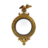 A Regency gilt framed convex mirror, with applied ball to the frame and an eagle to top. h.