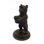 A black forest style carved pen holder, in the form of a standing bear h. 23.