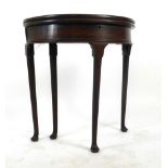 A mid Georgian mahogany demi lune tea table, the fold over top supported on single gate action,