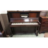 An early 20th century mahogany upright 'pianola' piano with a quantity of pianola rolls. h.